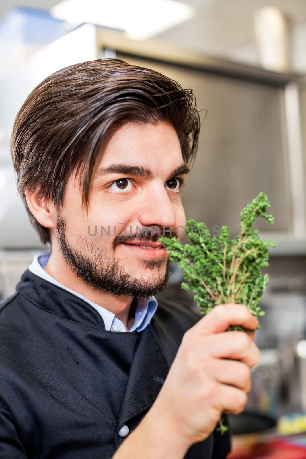 young chef in the restaurant kitchen with fresh arümatic spices