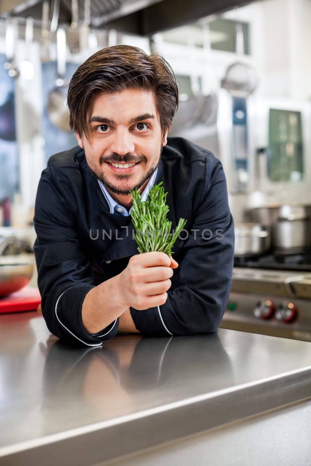 young chef in the restaurant kitchen with fresh arümatic spices
