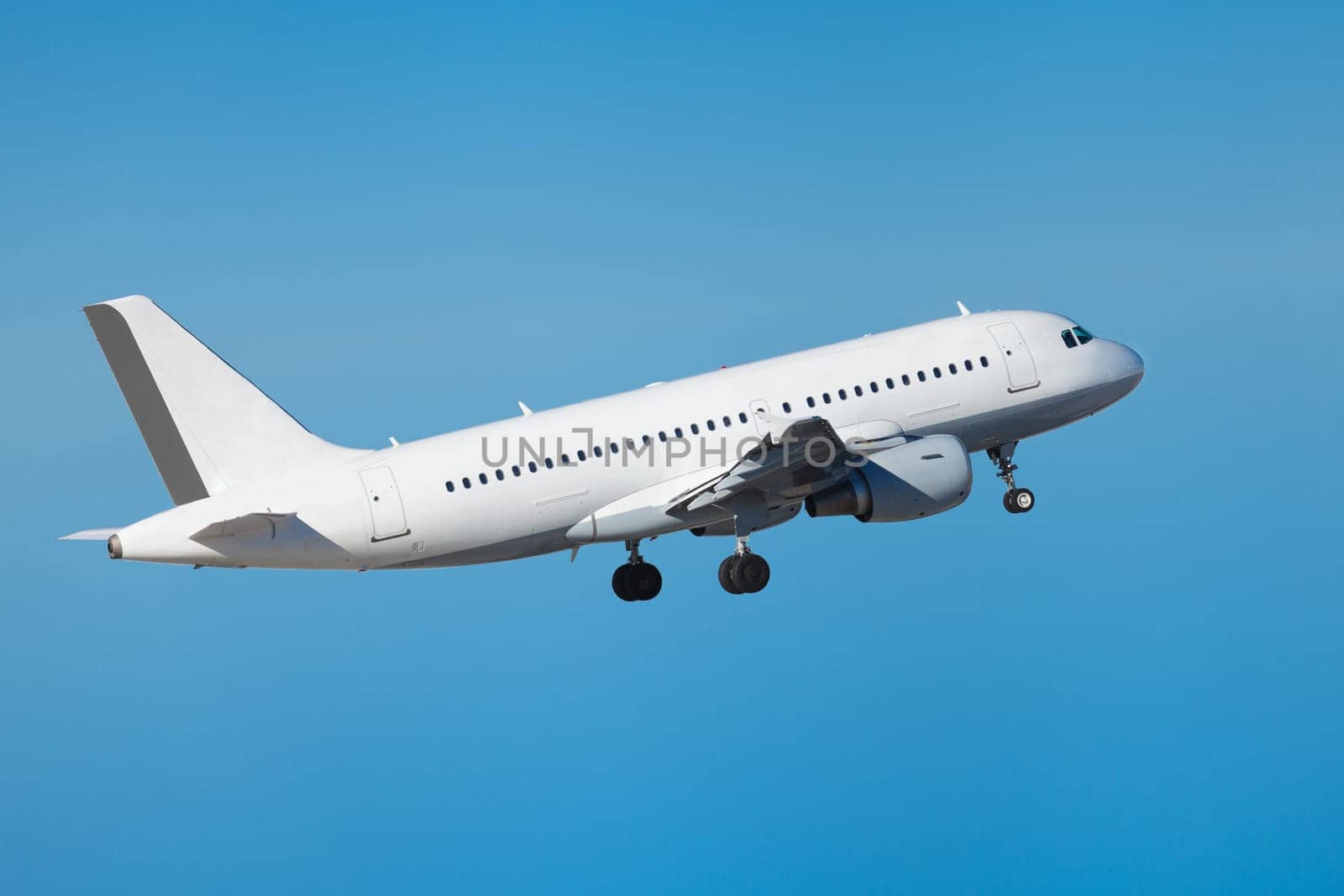large passenger plane in the air before blue sky holiday travel transport