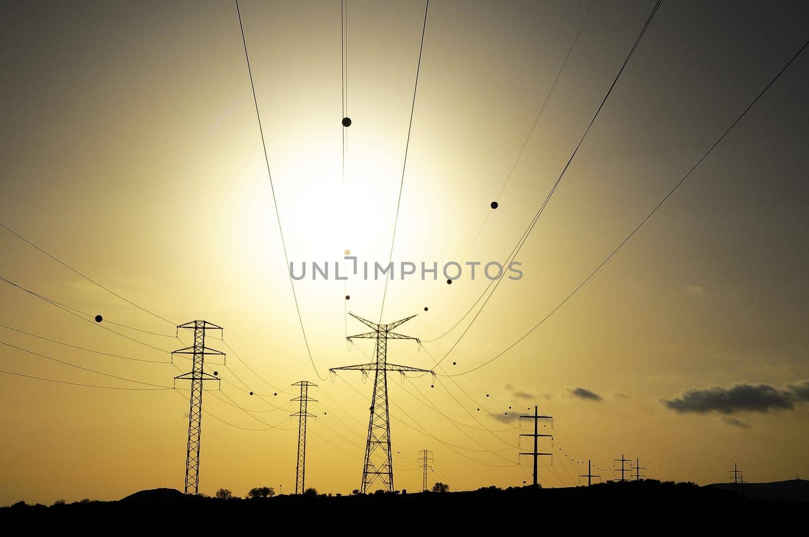 Electric Power Line Pylon over a colored Sunset