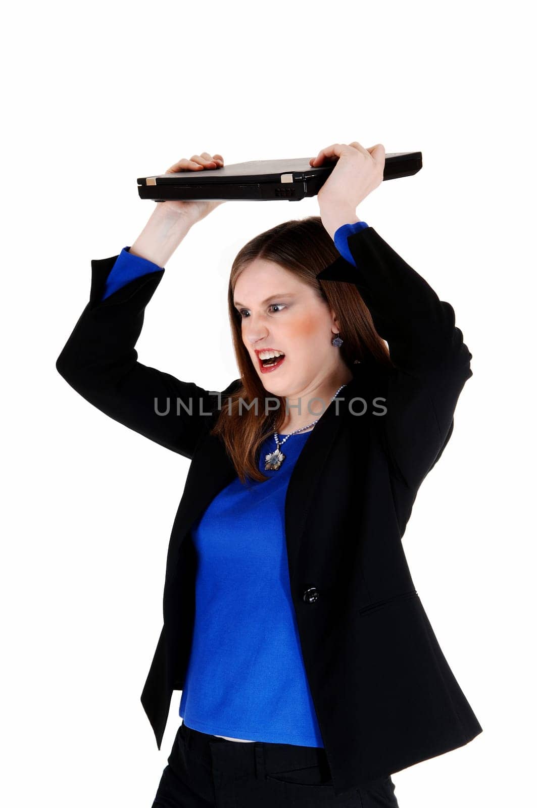A young business woman in a black suit throwing her laptop very angry,.for white background..