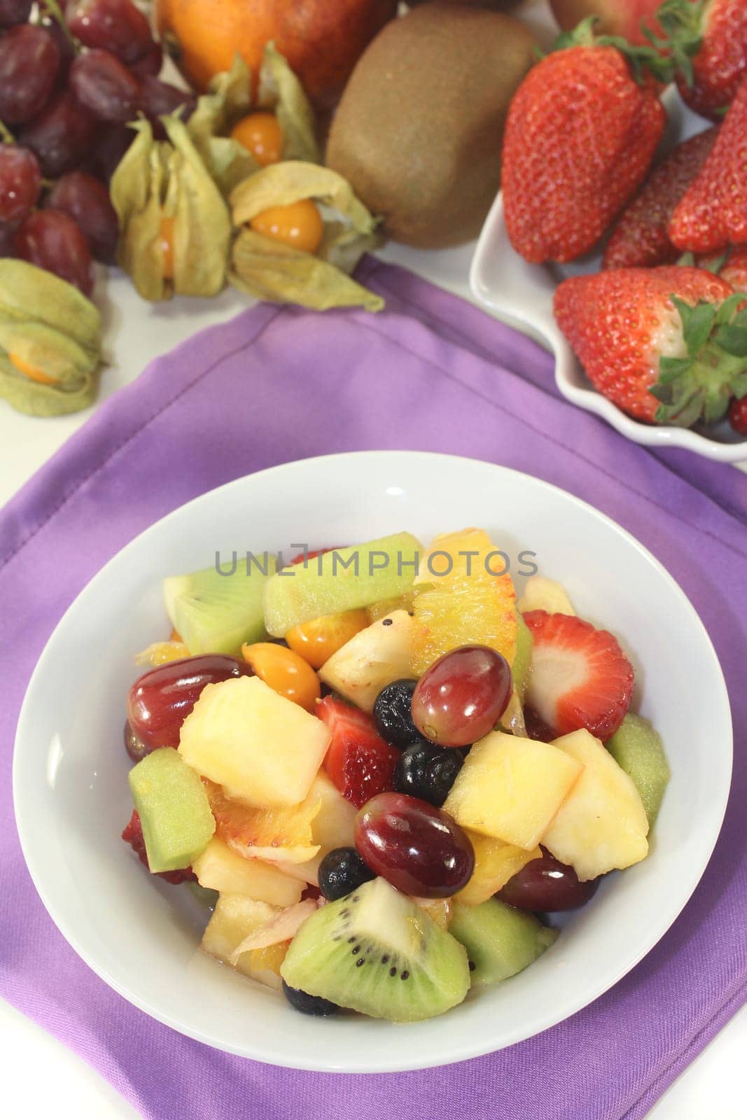 a white bowl with fresh fruit
