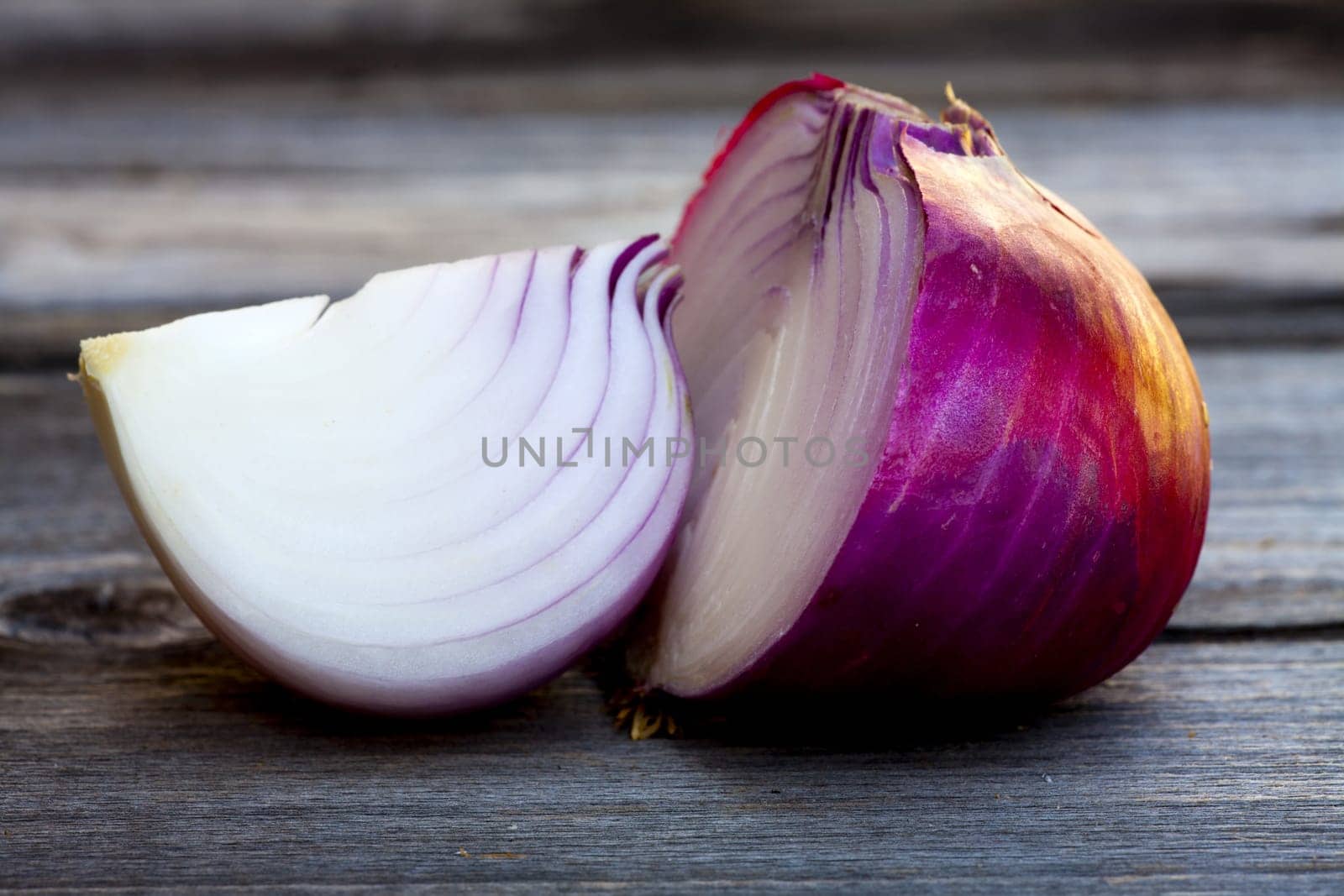 Close up view of fresh red onions on a old wooden Table