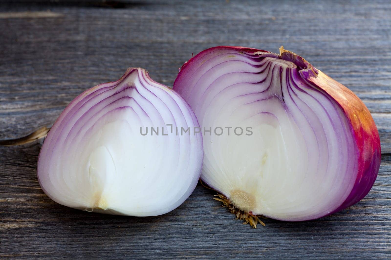 Close up view of fresh red onions on a old wooden Table