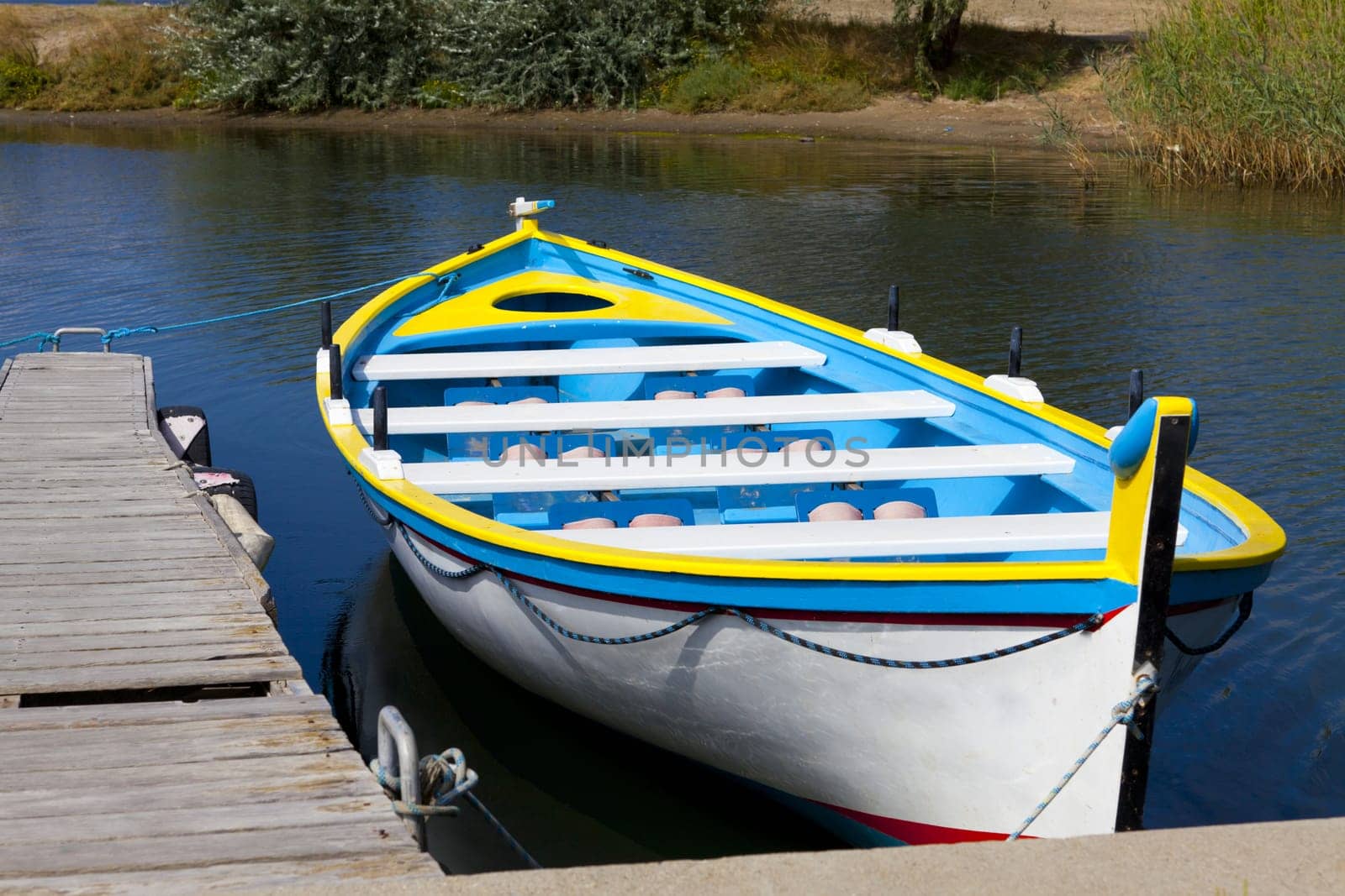 Colourful rowing boat to a jetty in Gruissan in southern France
