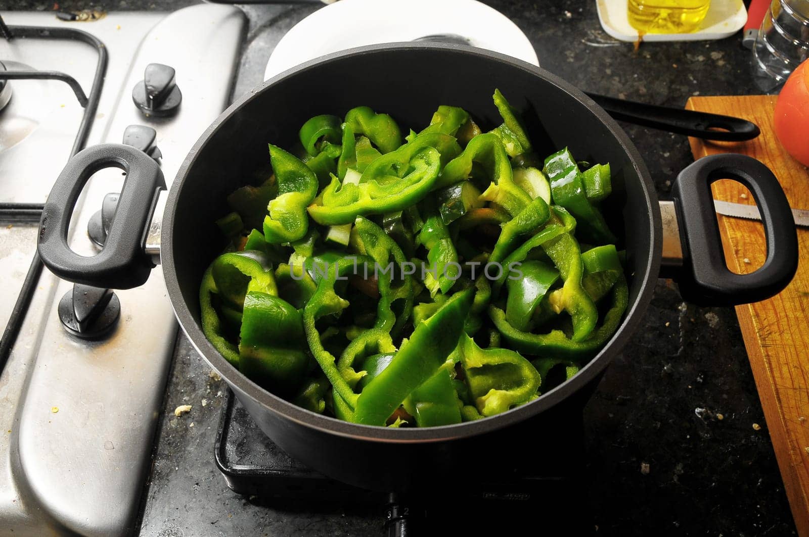 Coocking Green Chili Pepperson a Black Pot