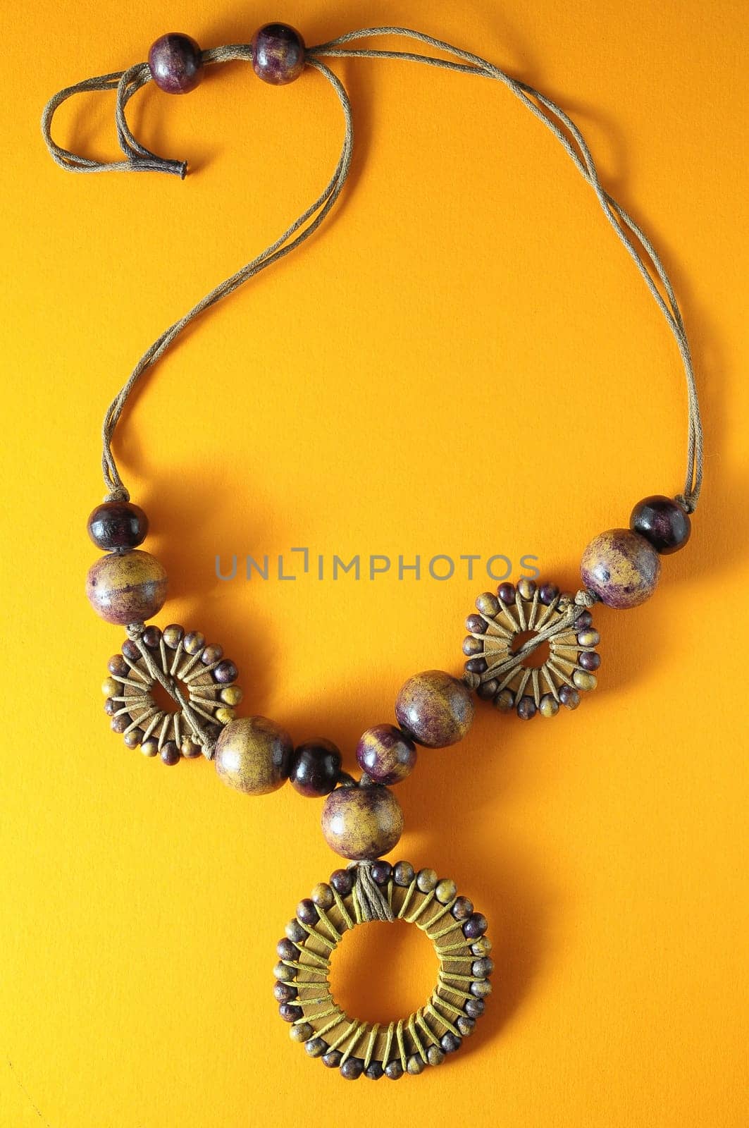 Handmade Wood Collar Necklace on a Colored Background