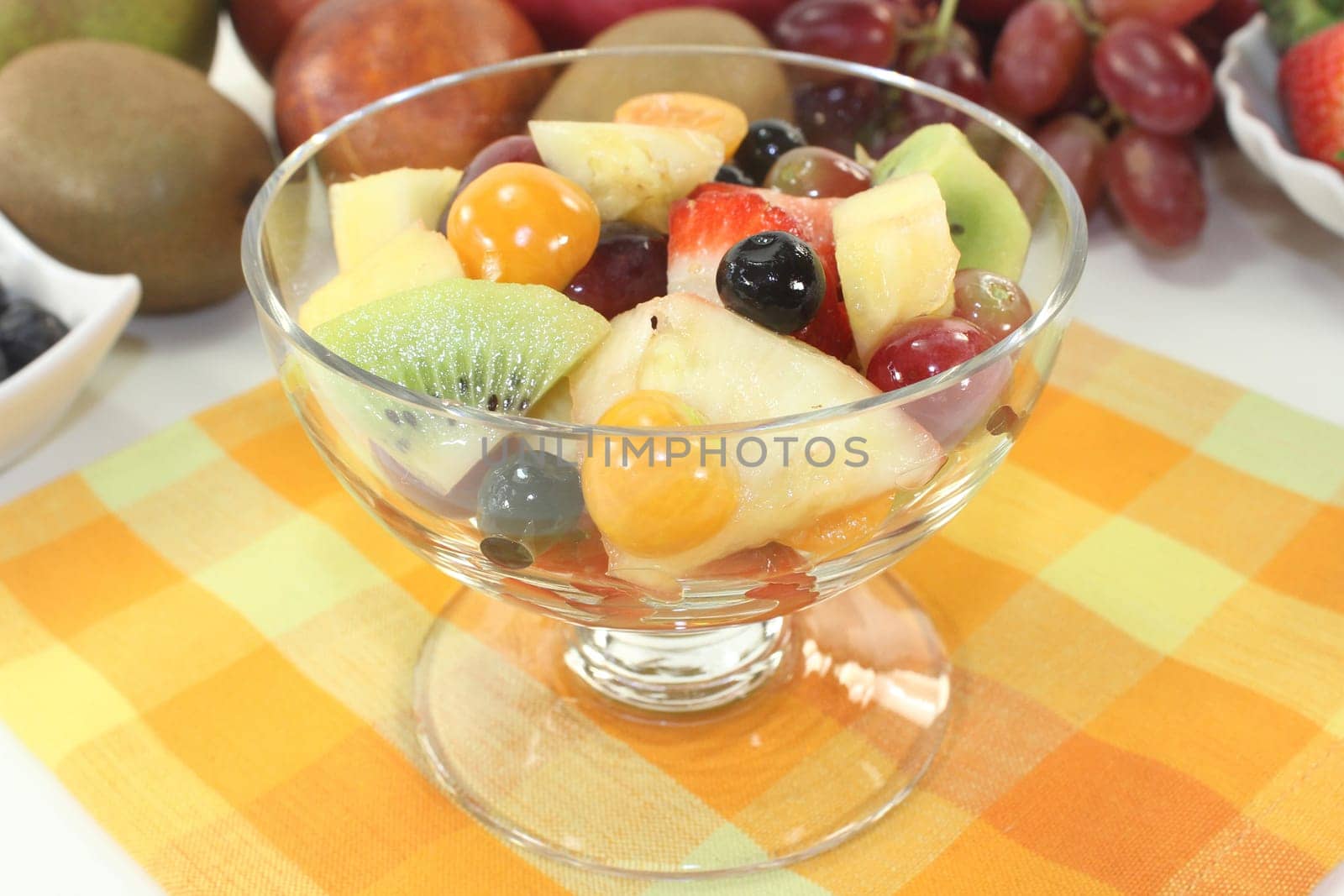 a cocktail bowl with fresh fruit salad