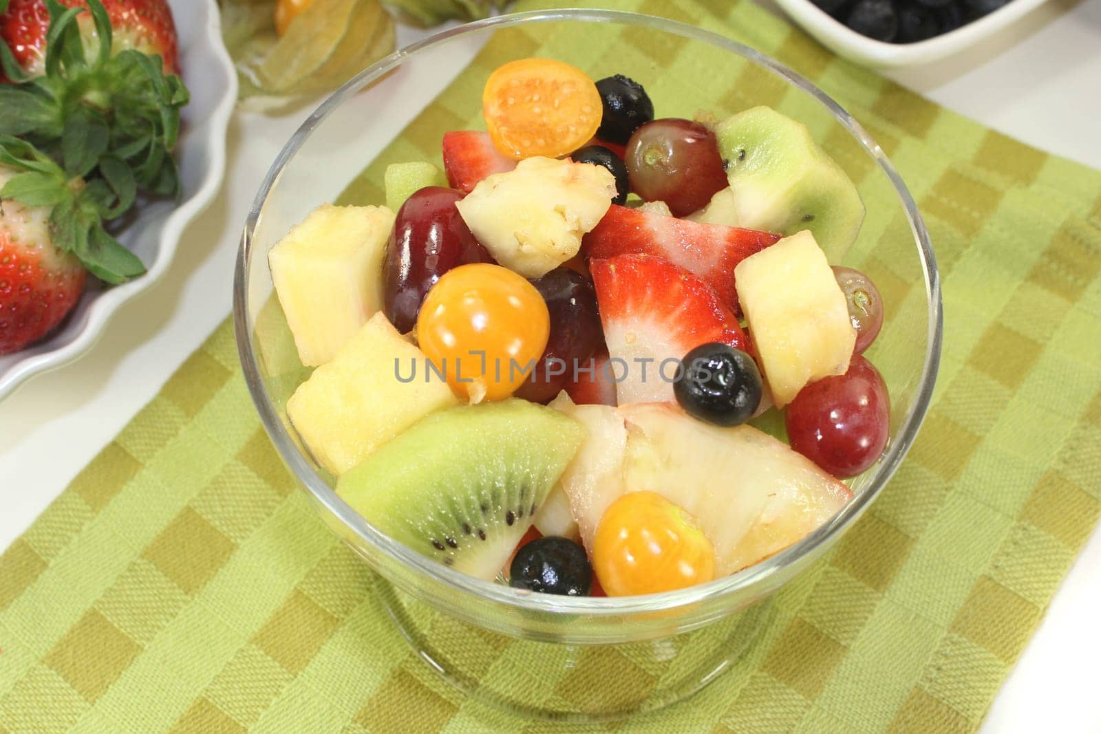 a cocktail bowl with fresh fruit salad