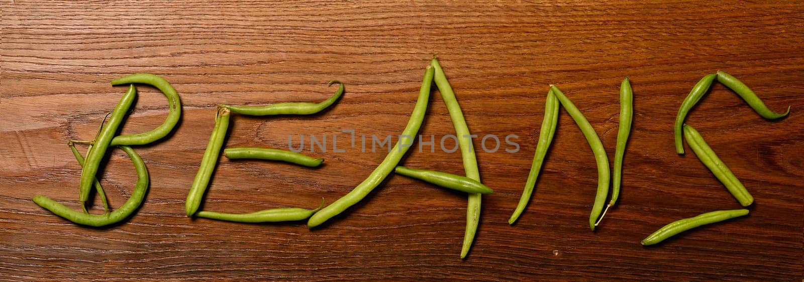 Green beans on a wooden background