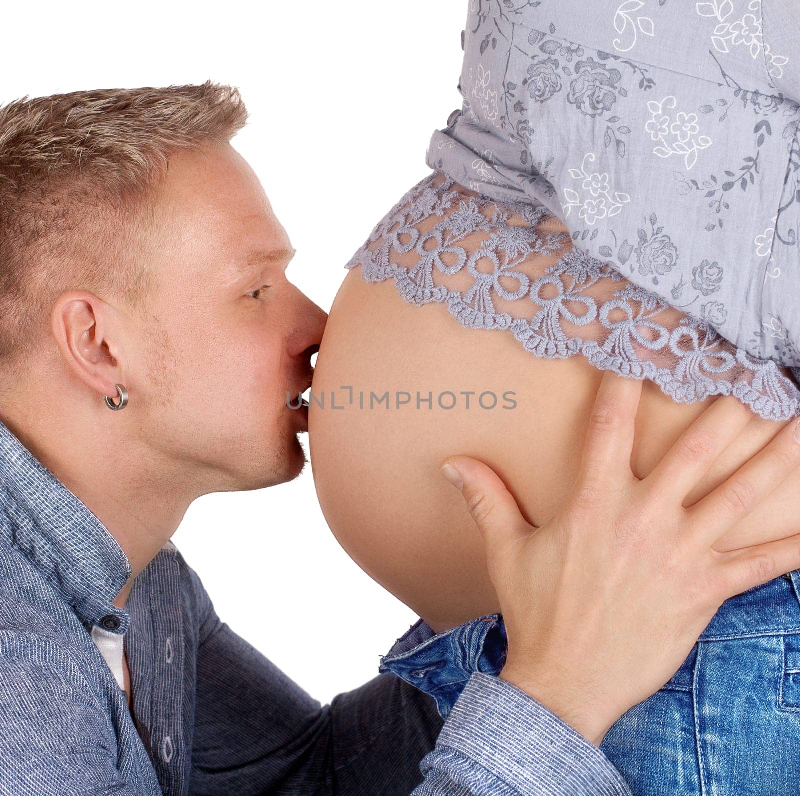 Father-to-be kisses baby belly