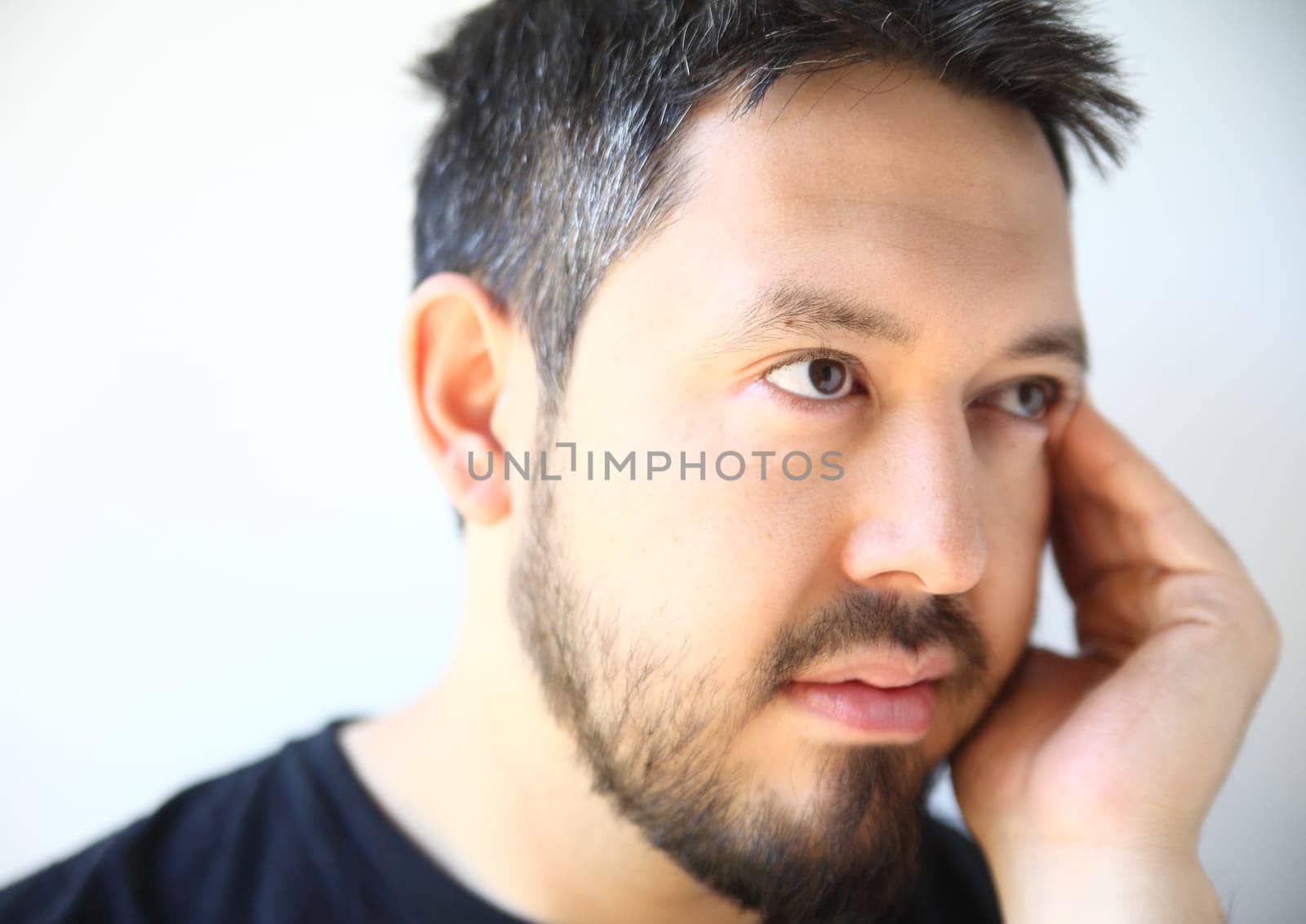 bearded thirty-something man with a pensive expression