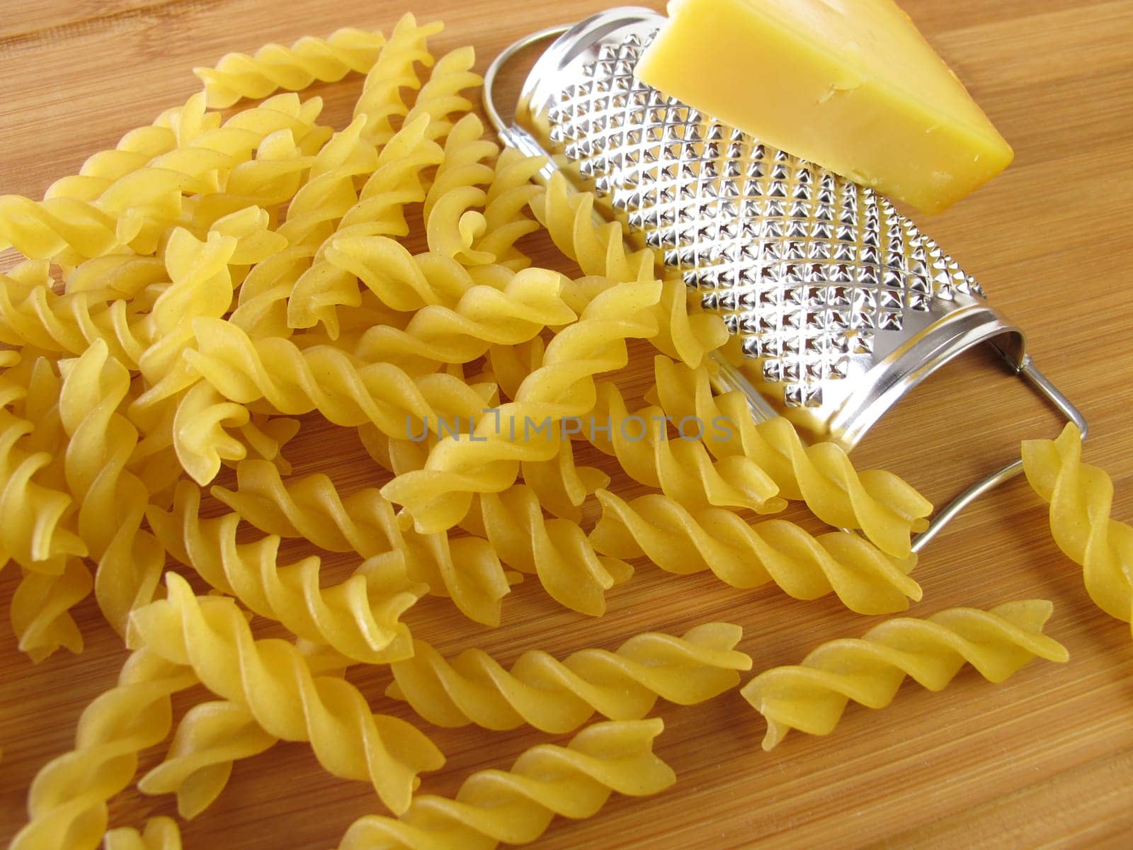 Noodles with small grater and a corner of cheese