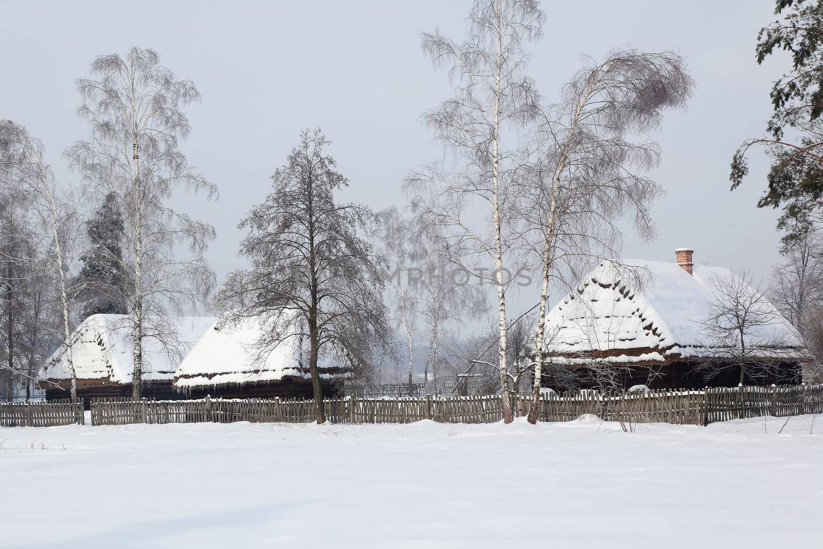 Old hauses with snow on the roof.