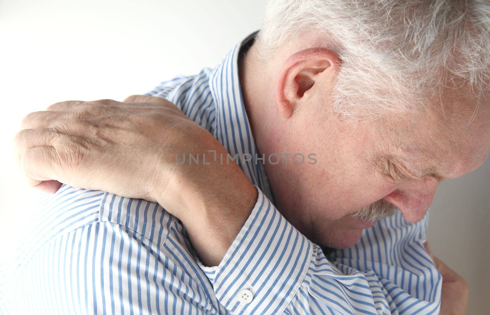 man stretches to reach an elusive itch
