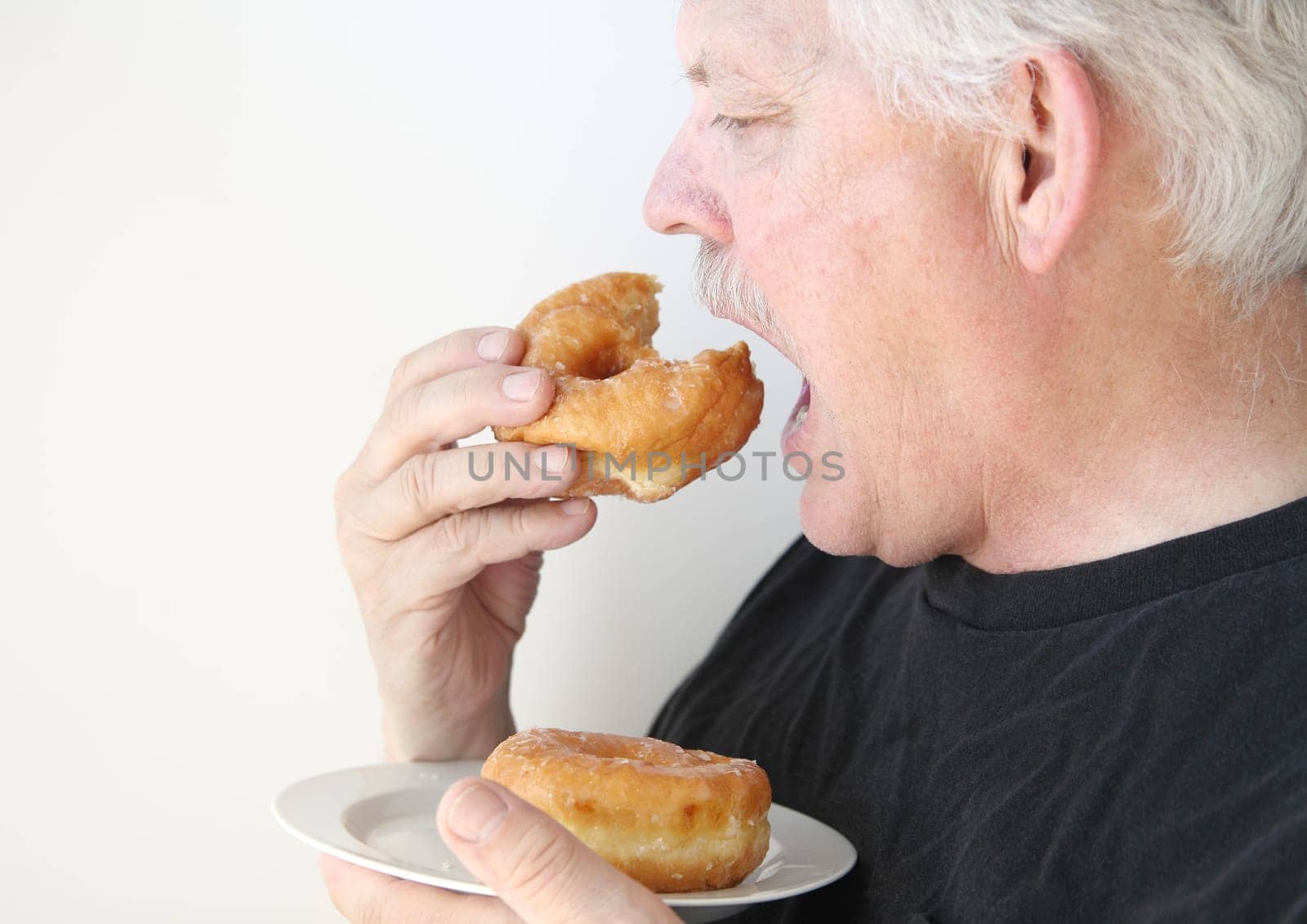 senior man enjoying unhealthy food