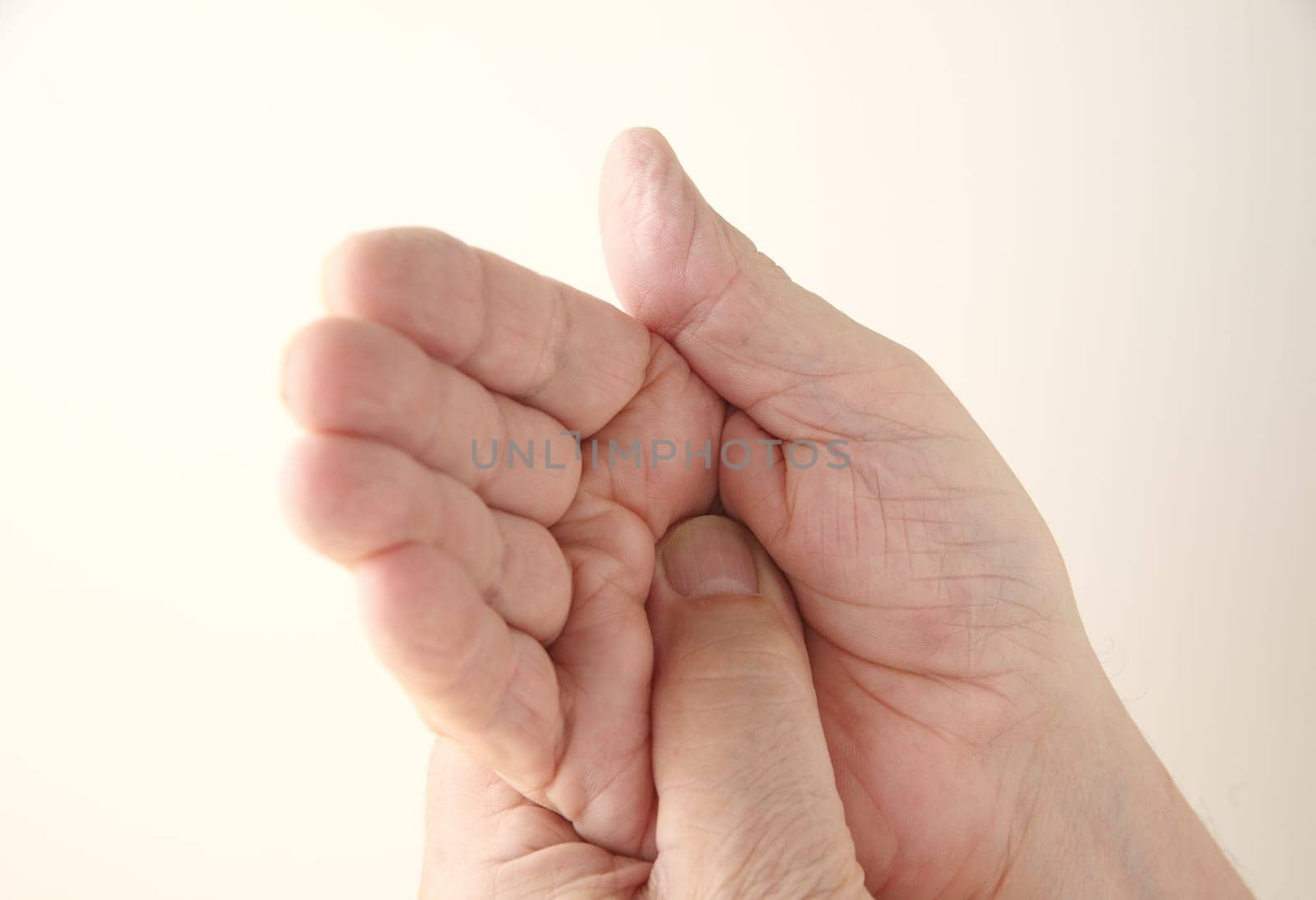 older man with pain in his palm