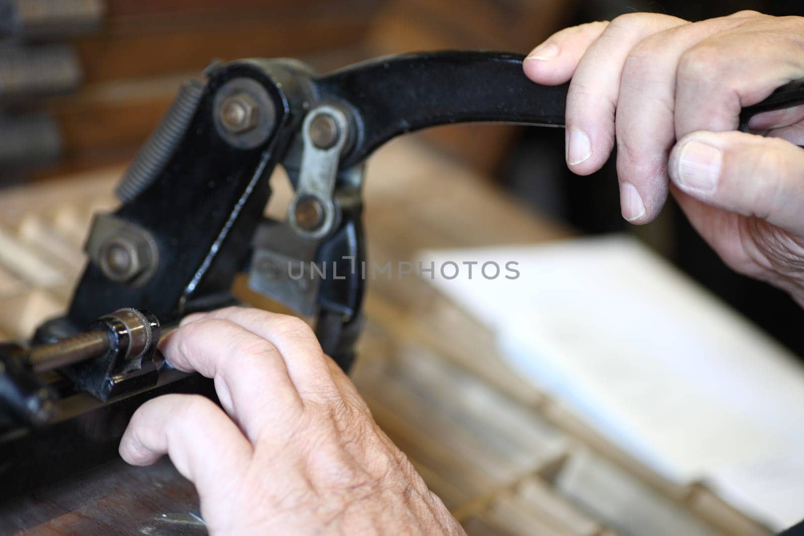 printer using a vintage cutter to trim metal pieces