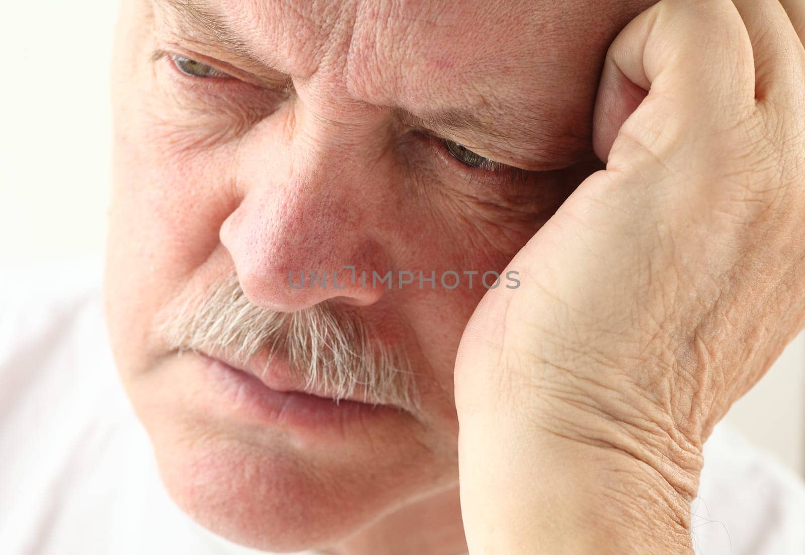 senior man with an unhappy expression