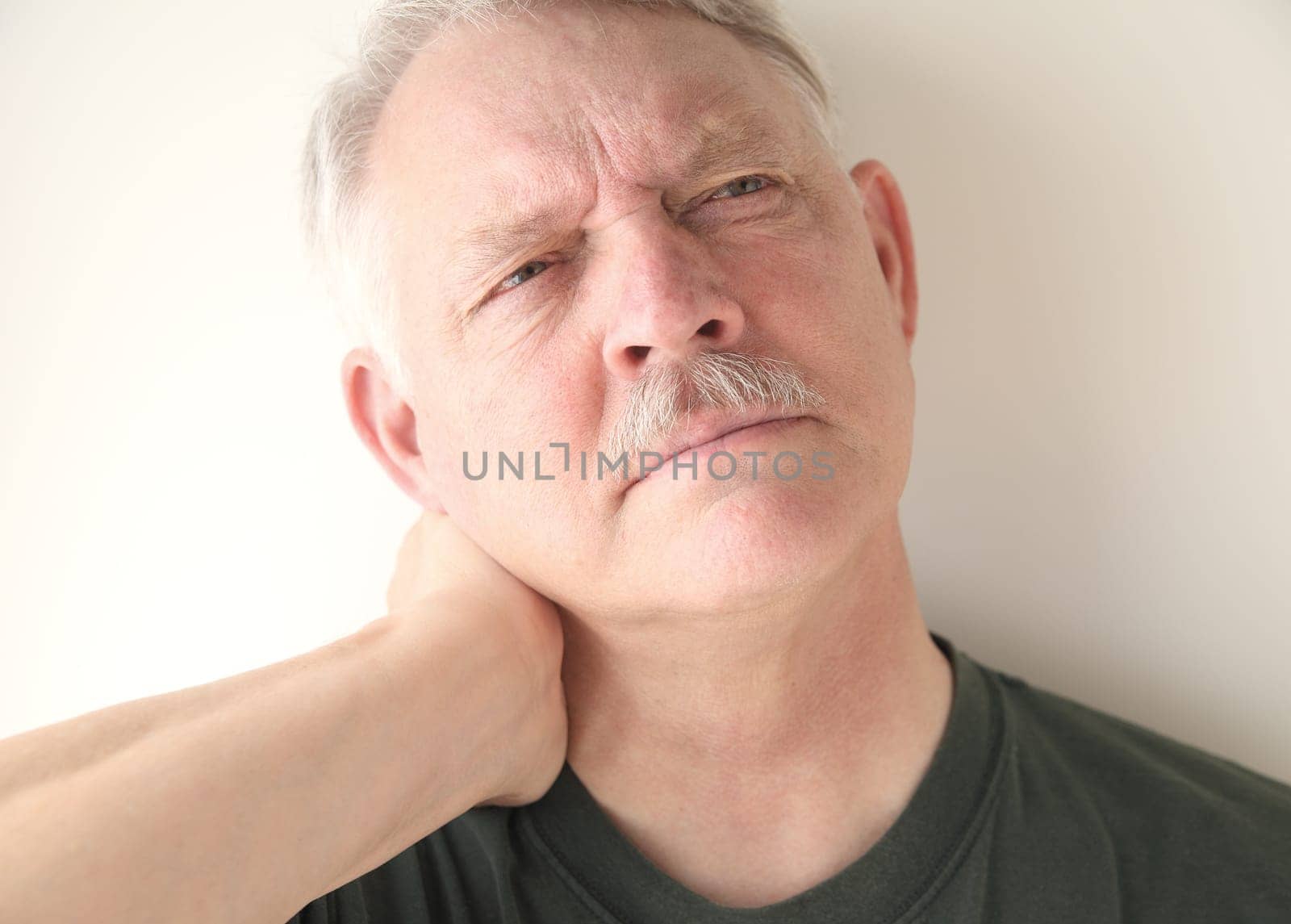 mature man with soreness in his neck