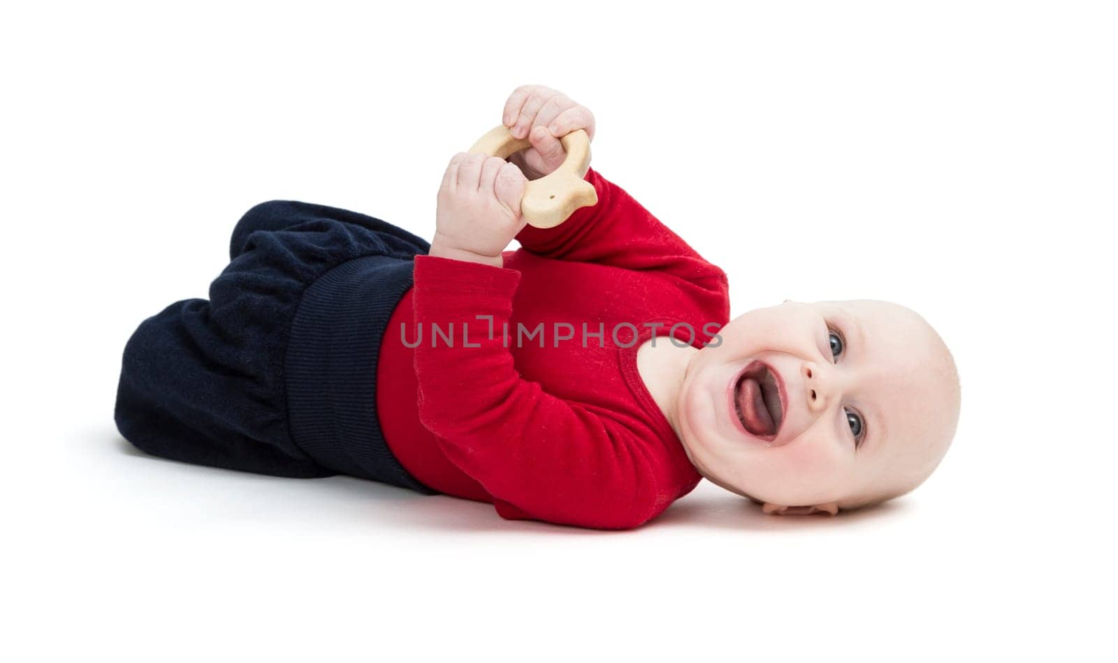 laughing baby in red shirt on floor. isolated on white background
