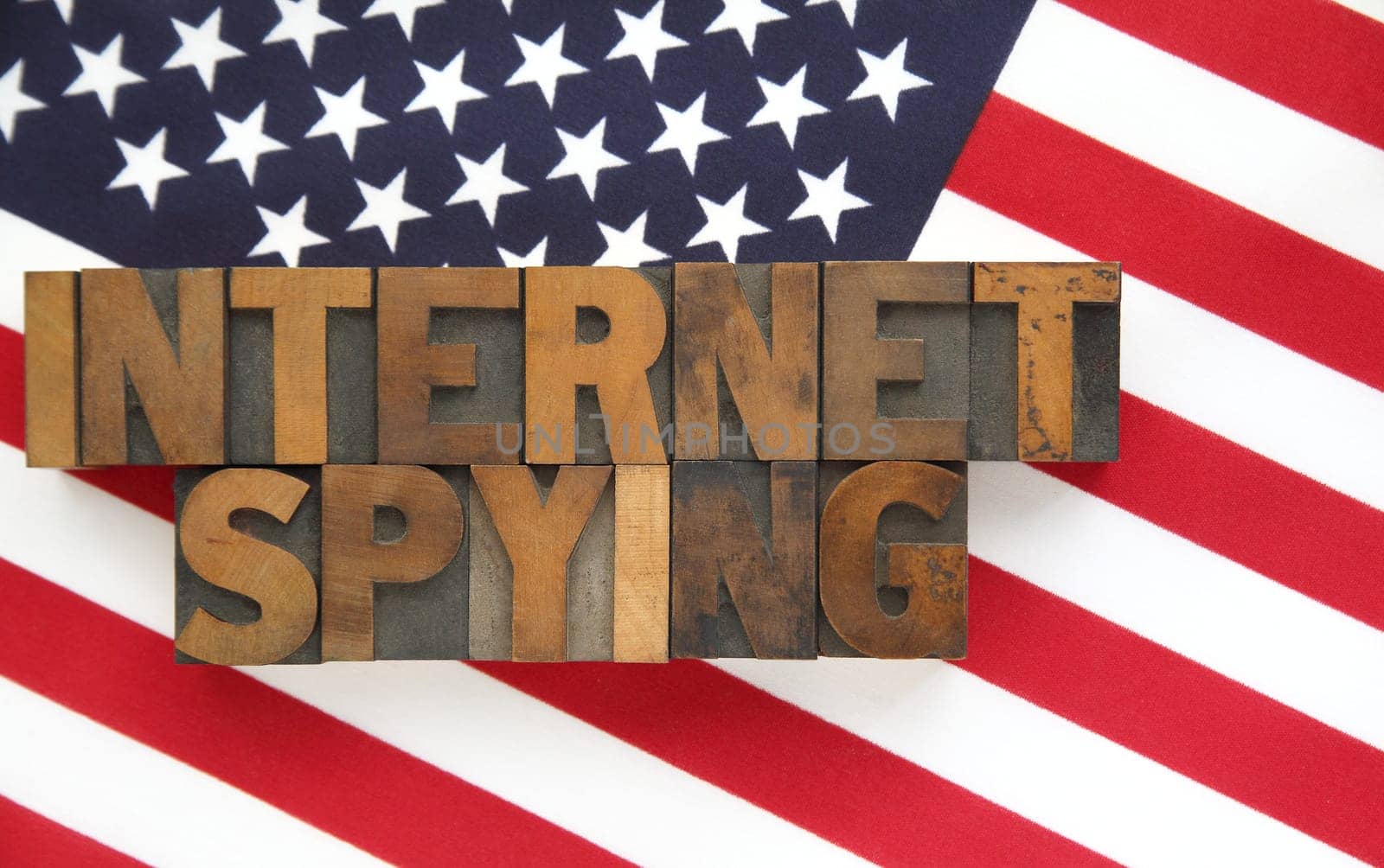 the words 'internet spying' on a USA flag
