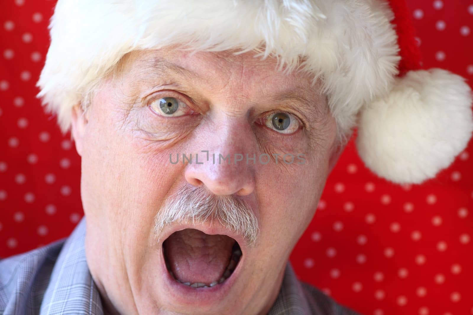 senior man looking surprised, overwhelmed or upset