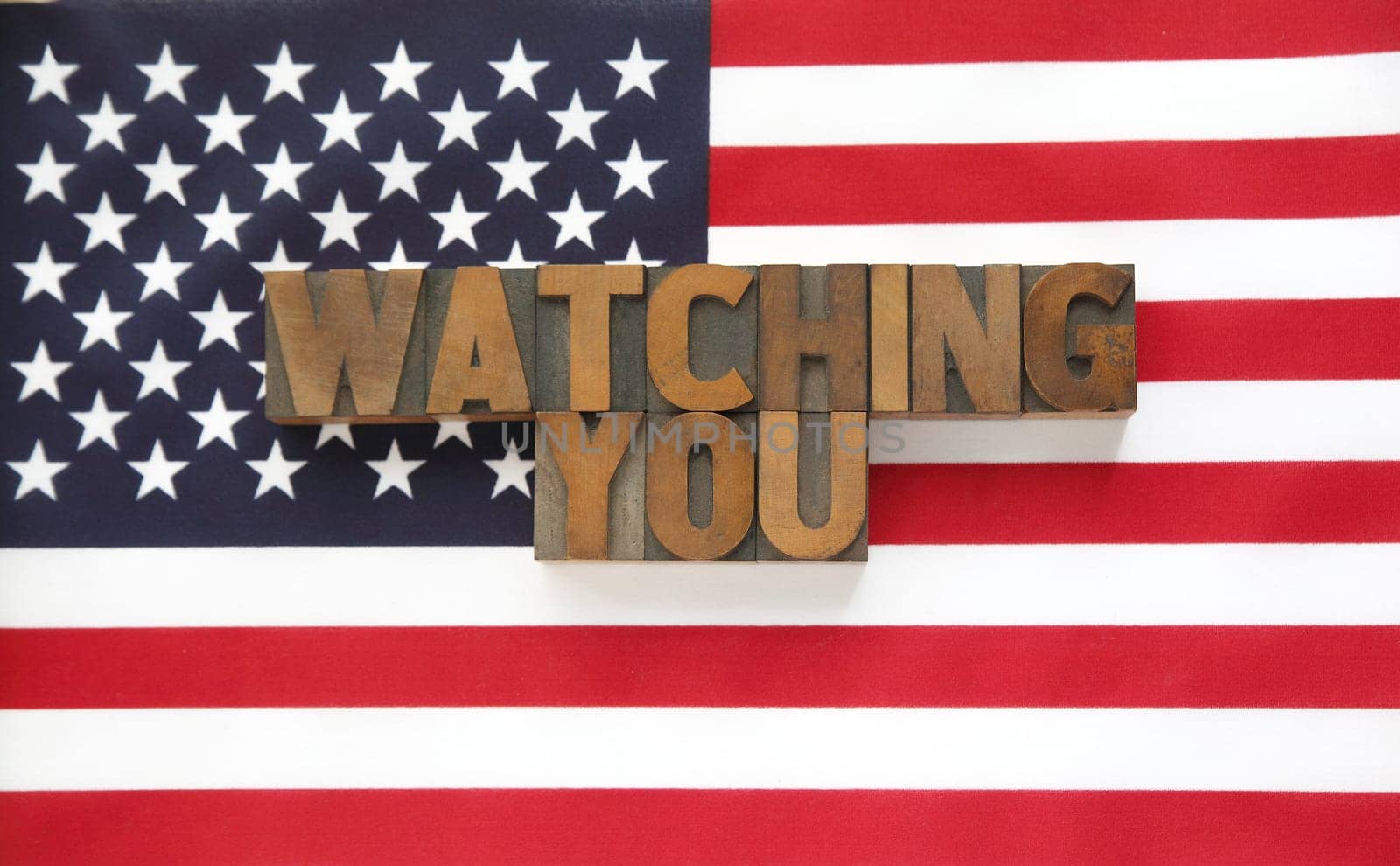 USA flag with the words watching you in letterpress wood type letters