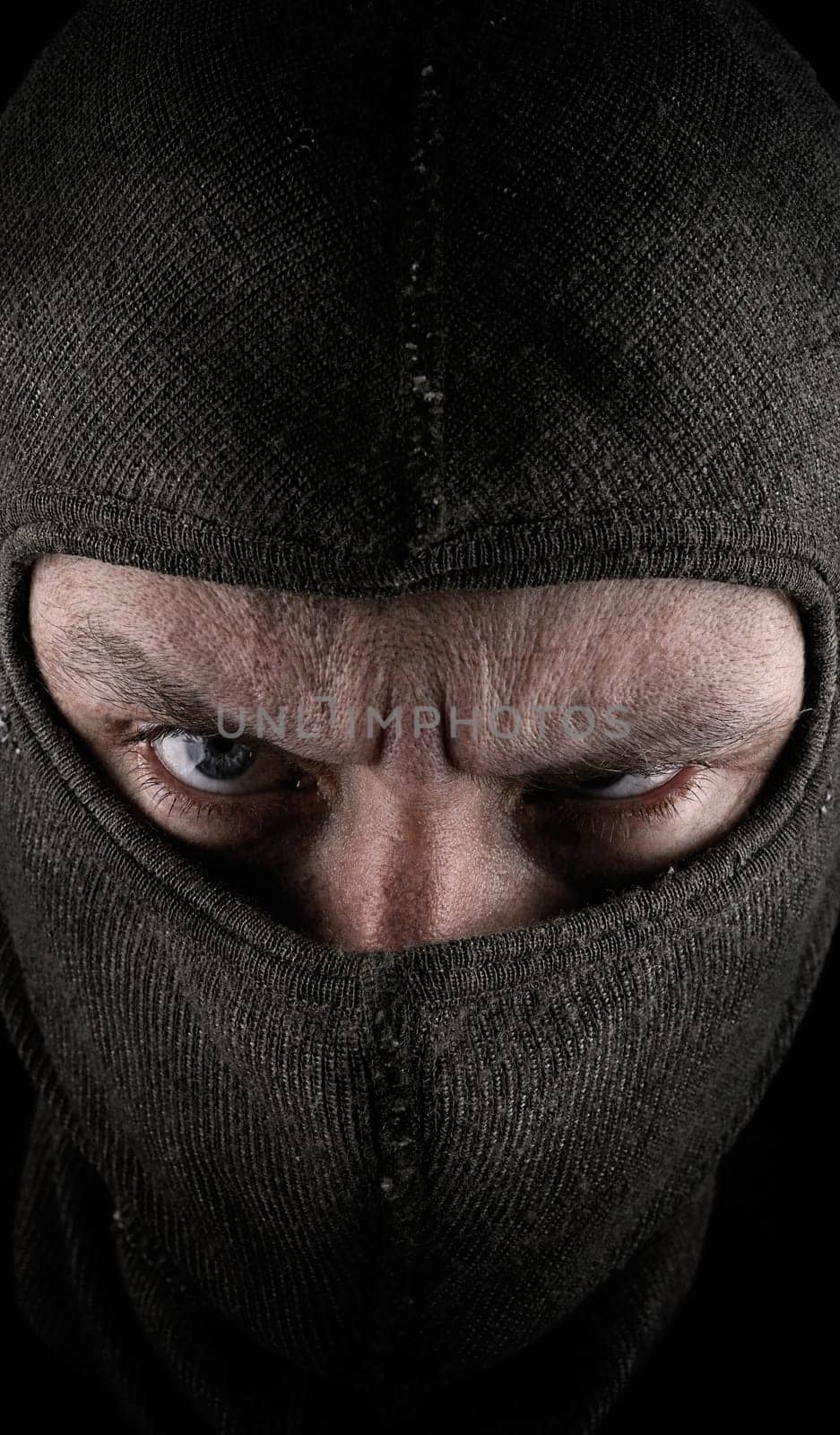 Masked man on a dark background