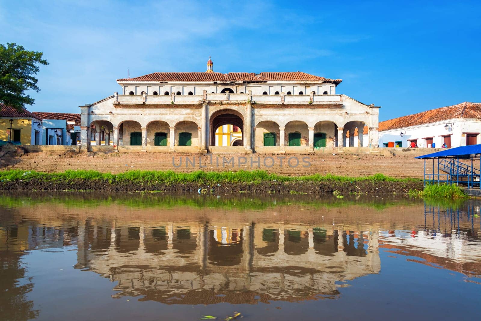 Old abandoned market in Mompox, Colombia reflected in the Magdalena River