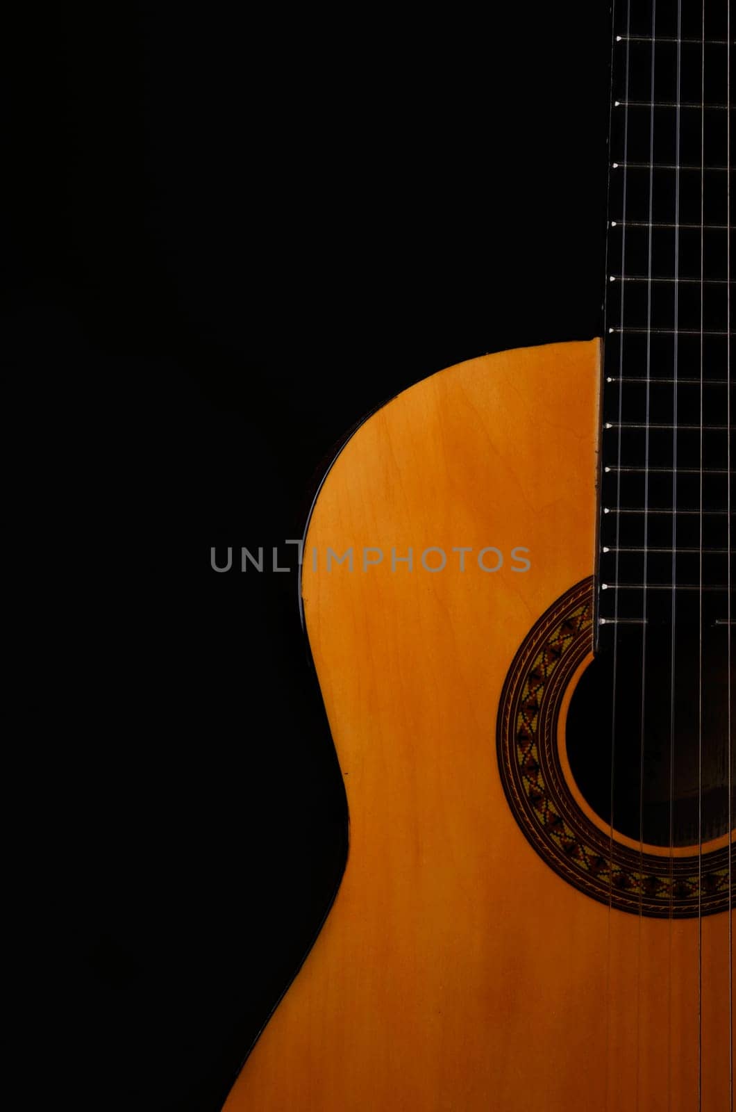 Acoustic guitar on a black background