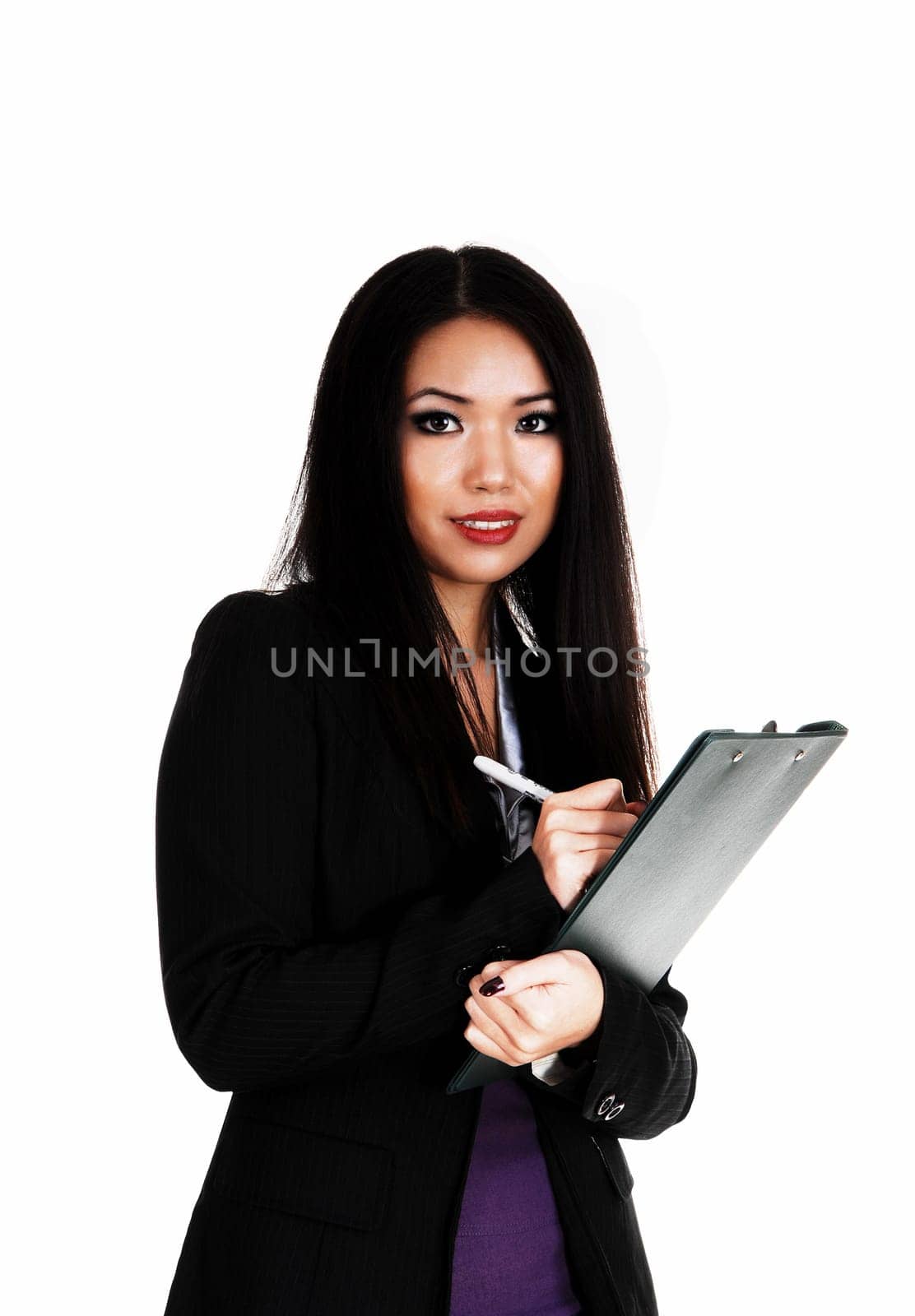 A beautiful young slim Asian business woman in a black jacket and.long black hair standing for white background..