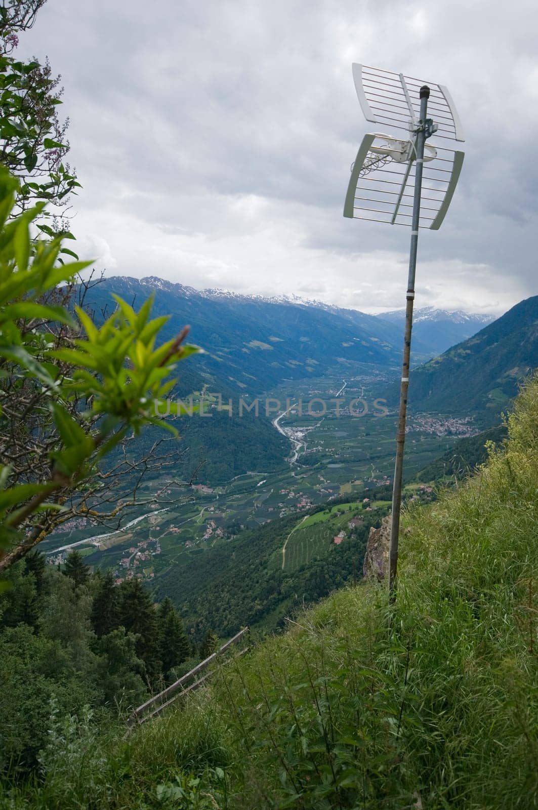 View of the Merano valley from above the hochmuth mountain station with antenna in the foreground