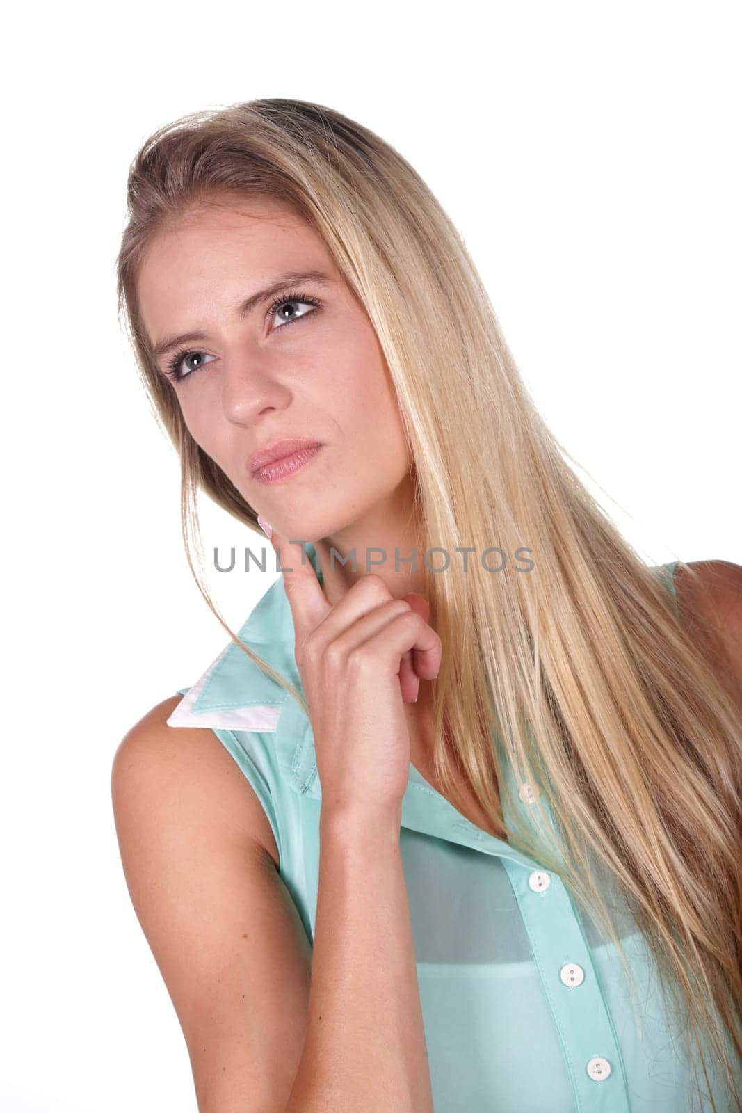 Pensive young lady with hand on chin and looking upward