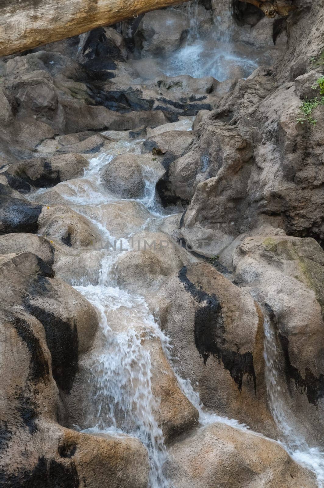 Small River Waterfall Between some Brown Rocks