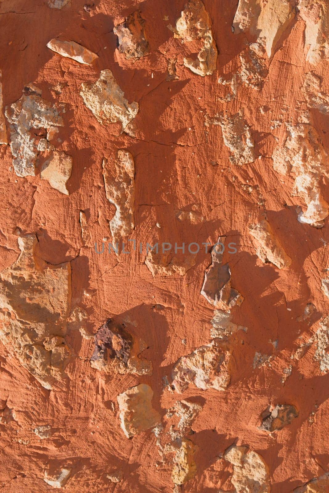 Detailed view of the ocher wall (Roussillon, Vaclause, Provence, France). Vertically.