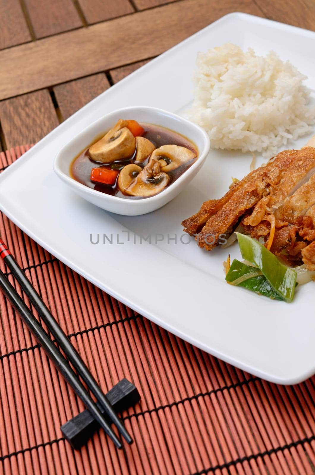 Asian fried chicken with rice and paprika mushrooms souce