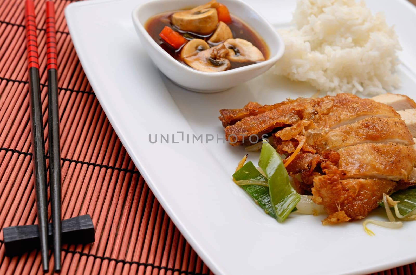 Asian fried chicken with rice and paprika mushrooms souce