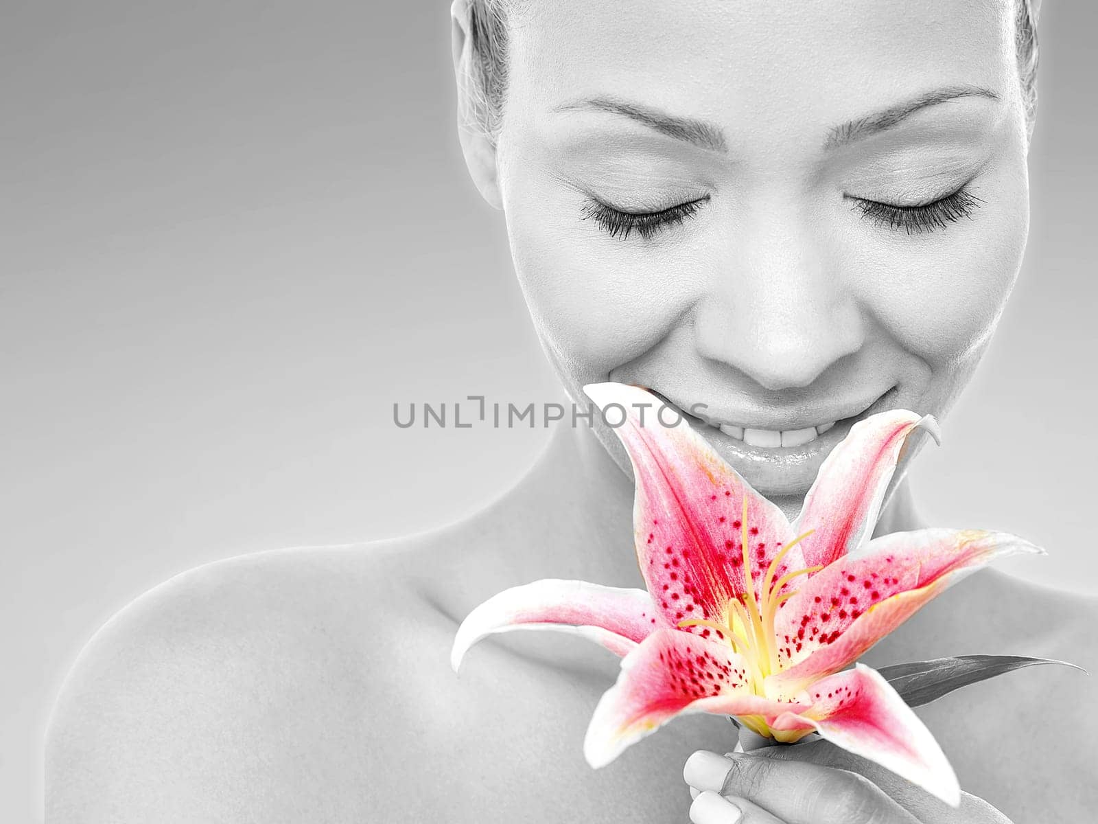 Calm beautiful lady holding lily flower