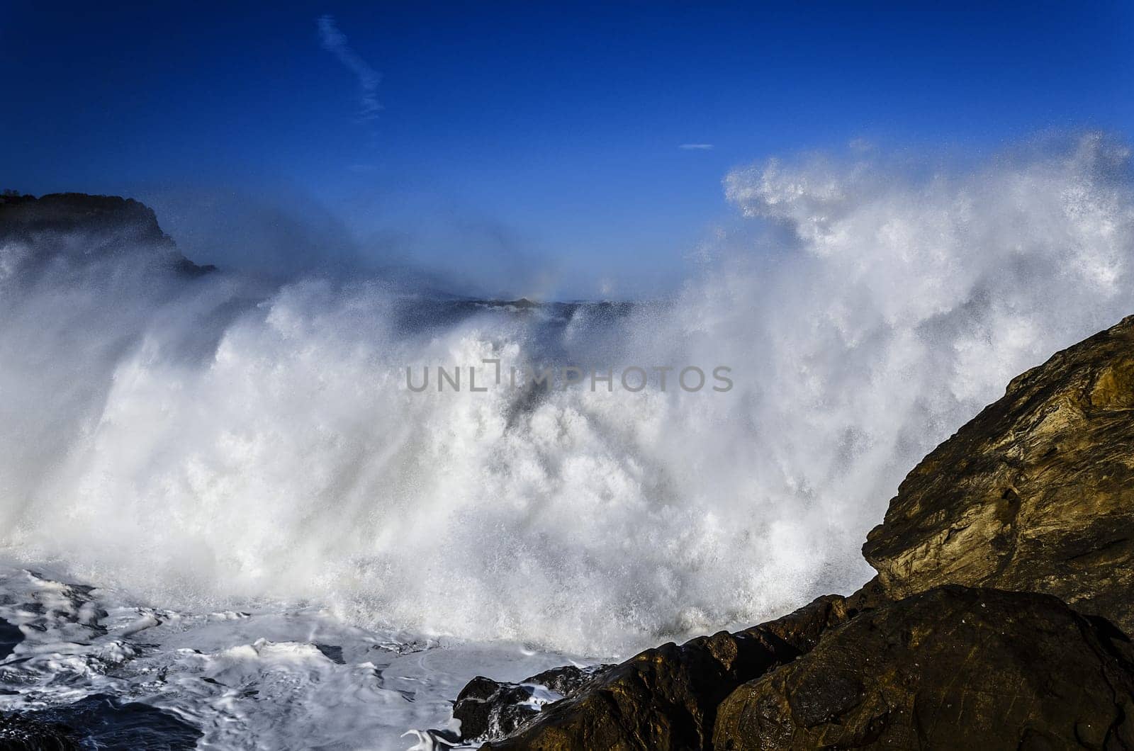 Beautiful splashing wave in to the rocks, with great details and quality. The image is takken in Spain, Getaria city at the Atlantic ocean.