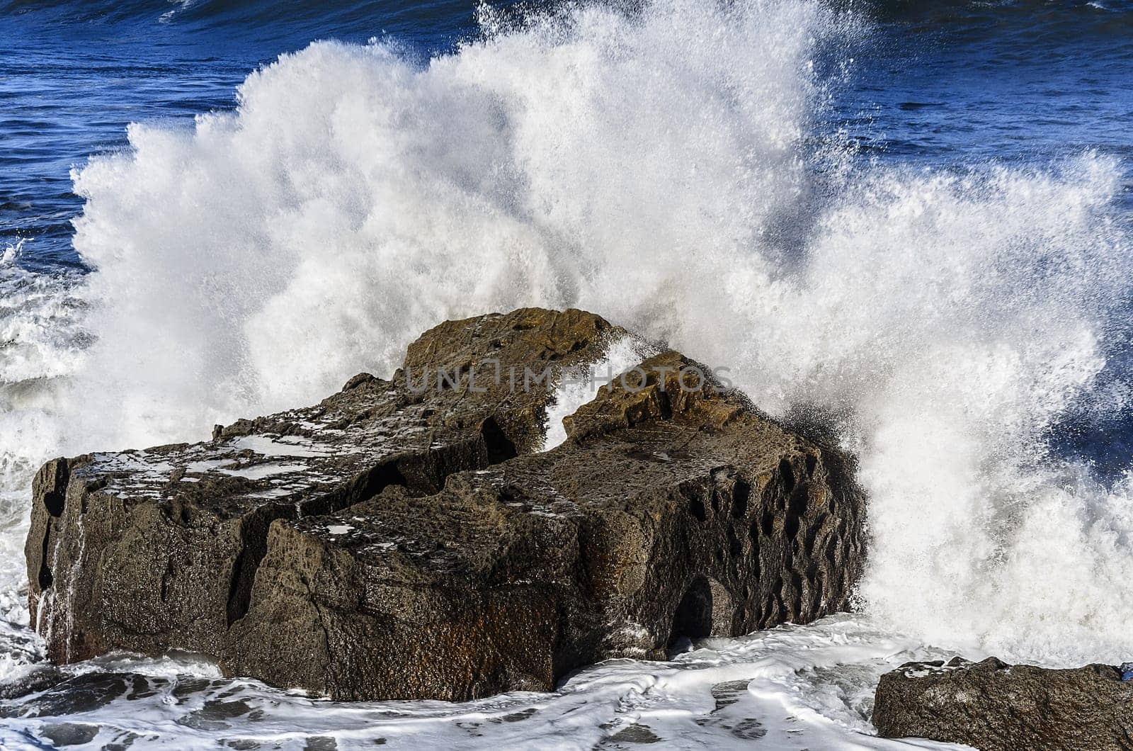 Beautiful splashing wave in to the rocks, with great details and quality. The image is takken in Spain, Getaria city at the Atlantic ocean.