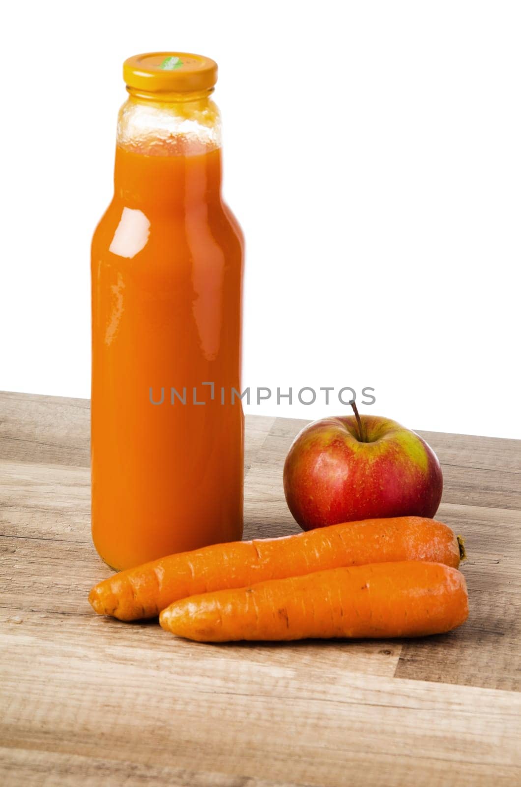 Bottle with carrots juice and an apple, it is isolated on white