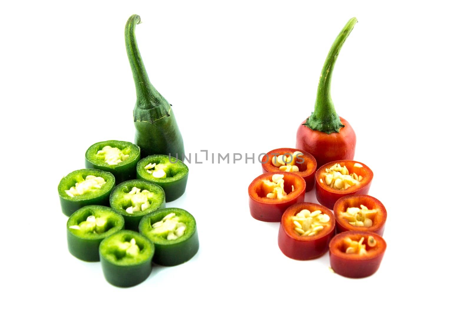 red and green hot chili pepper slices on a white background