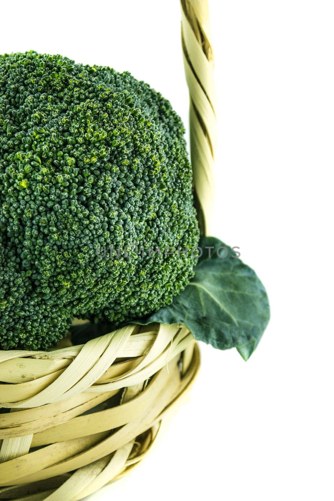 Fresh broccoli in Straw basket on white background.