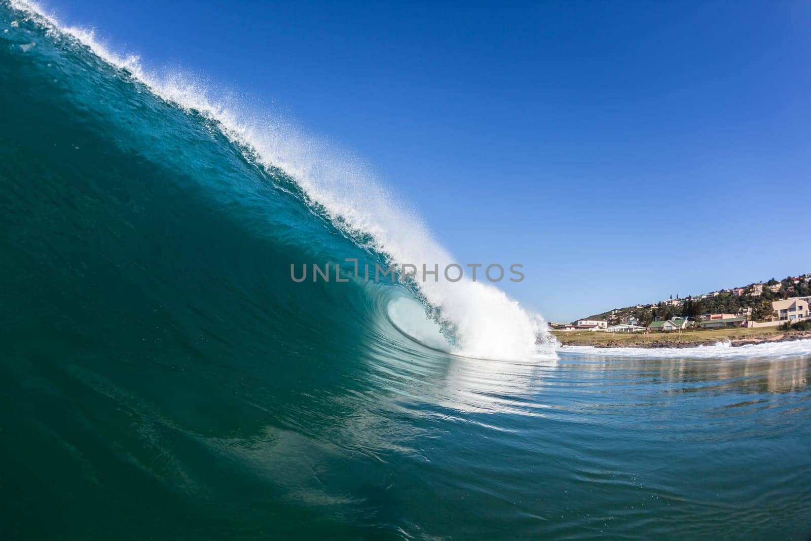 Ocean wave wall from storm swells crashing along shallow beach reef with natures  energy, a swimming photo of sea power.