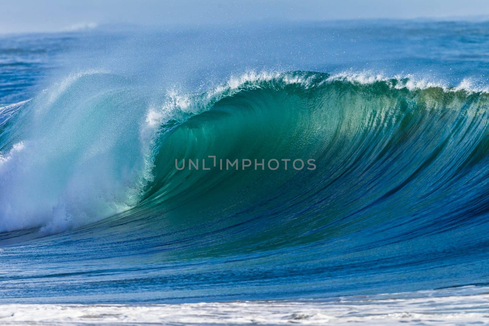 Ocean wave wall from storm swells crashing along shallow beach reef with natures  energy, a swimming photo of sea power.