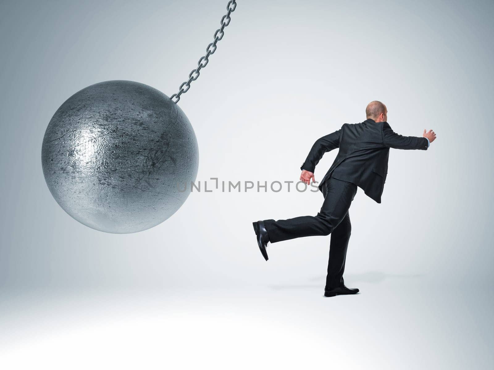 3d image of huge swinging metal ball and businessman