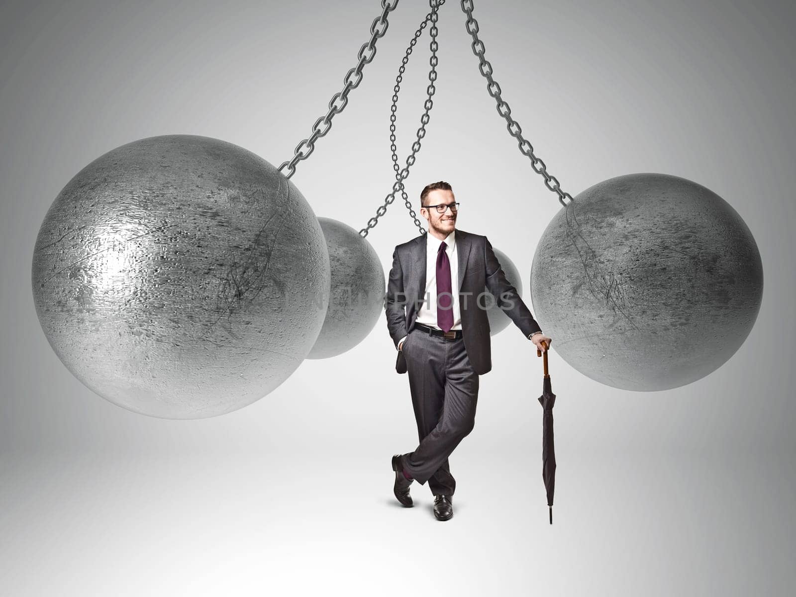 3d image of huge swinging metal ball and businessman