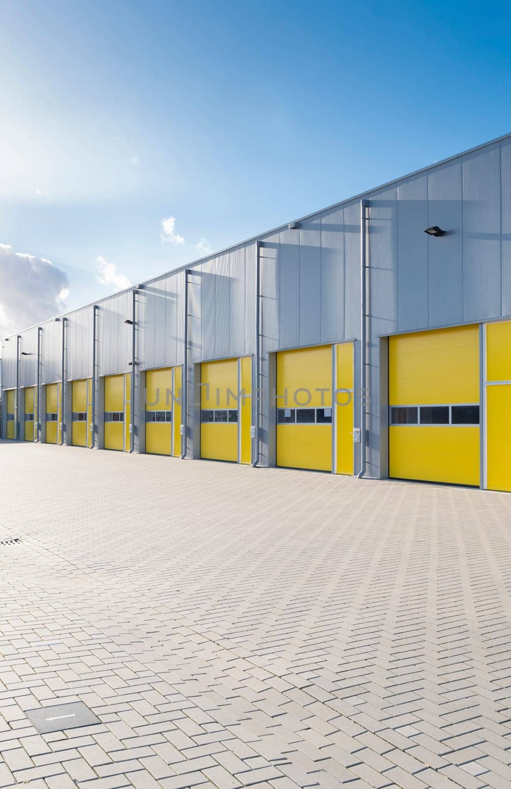exterior of a commercial warehouse with yellow roller doors