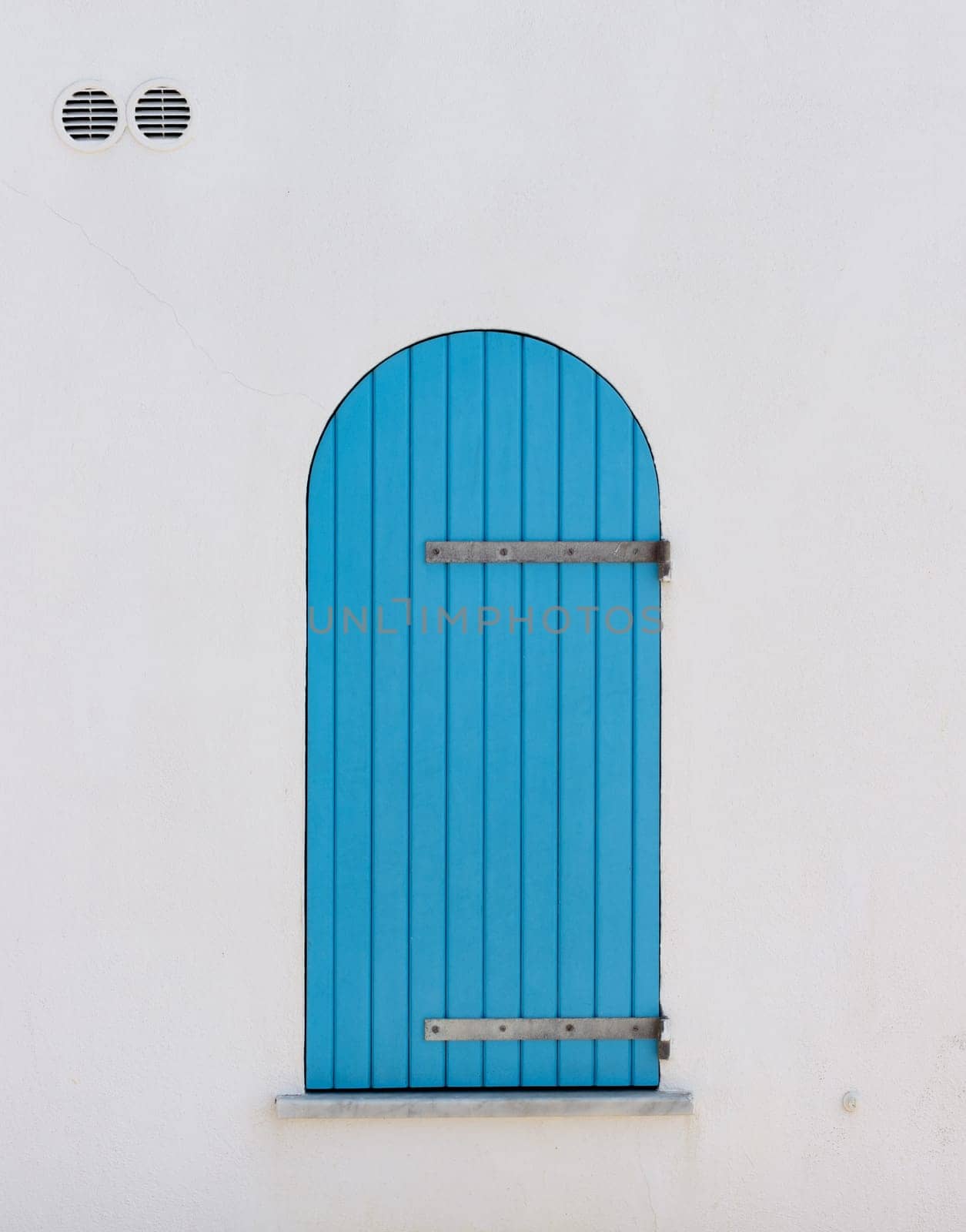 Colored panel of a wooden window typical of the seaside in Sardinia